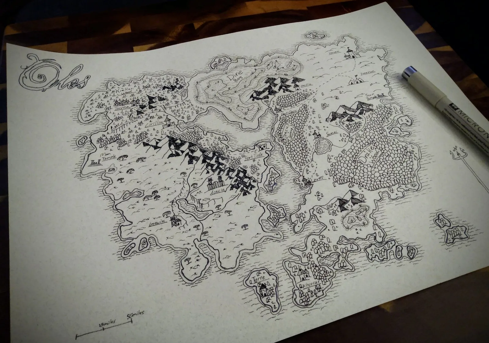 Hand drawn fantasy campaign map with a pen on a table